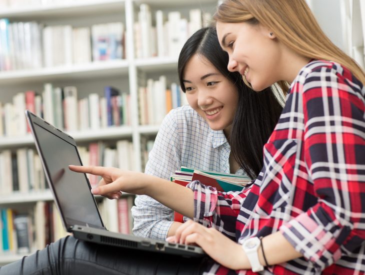 International female friends studying at the library together