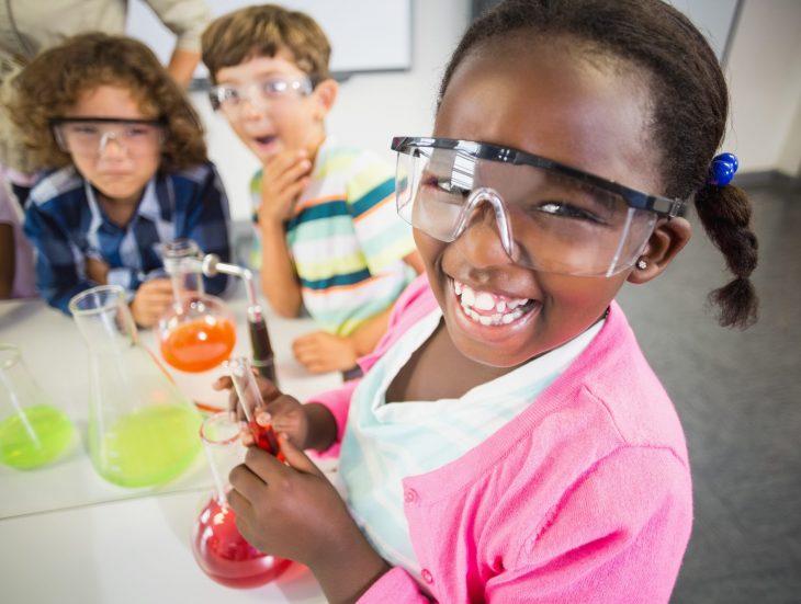 Kids doing a science experiment in laboratory