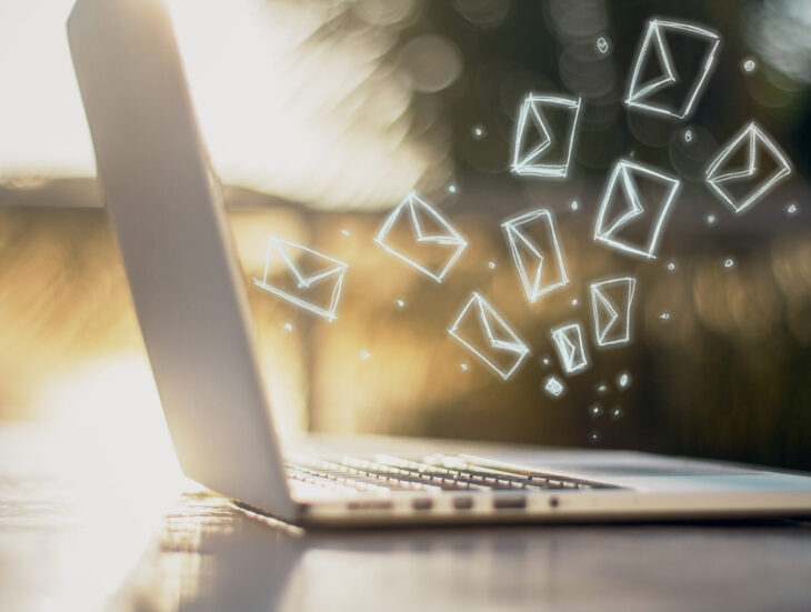 Laptop with newsletter icons